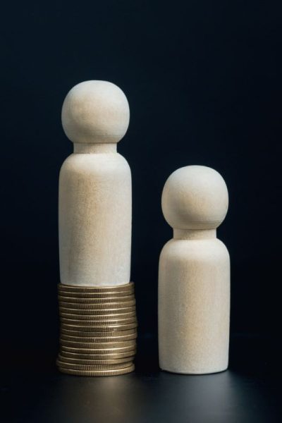 wooden-dolls-standing-on-stack-of-coins-goal-achi-2023-11-27-05-25-29-utc